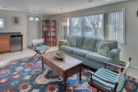a living room with furniture and a book shelf