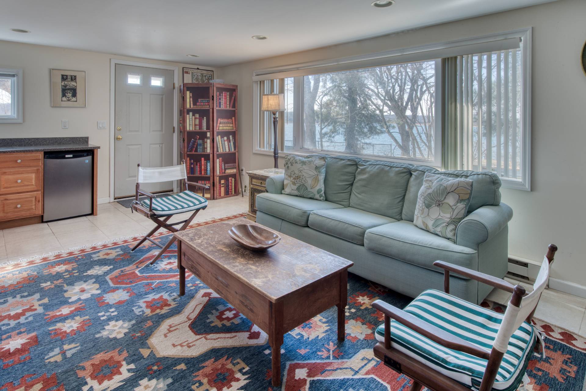 140 Redwood Road Sag Harbor, NY 11963 - Photo 10 of 14 a living room with furniture and a book shelf