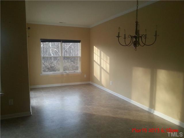 14411 Hamletville Street Raleigh, NC 27614 - Photo 5 of 16 a view of an empty room with windows