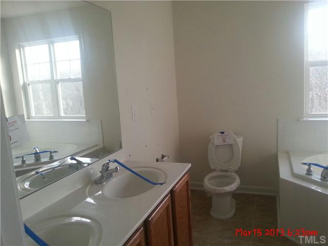 14411 Hamletville Street Raleigh, NC 27614 - Photo 7 of 16 a bathroom with a sink toilet and window