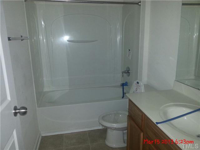 14411 Hamletville Street Raleigh, NC 27614 - Photo 8 of 16 a bathroom with a sink a toilet and shower