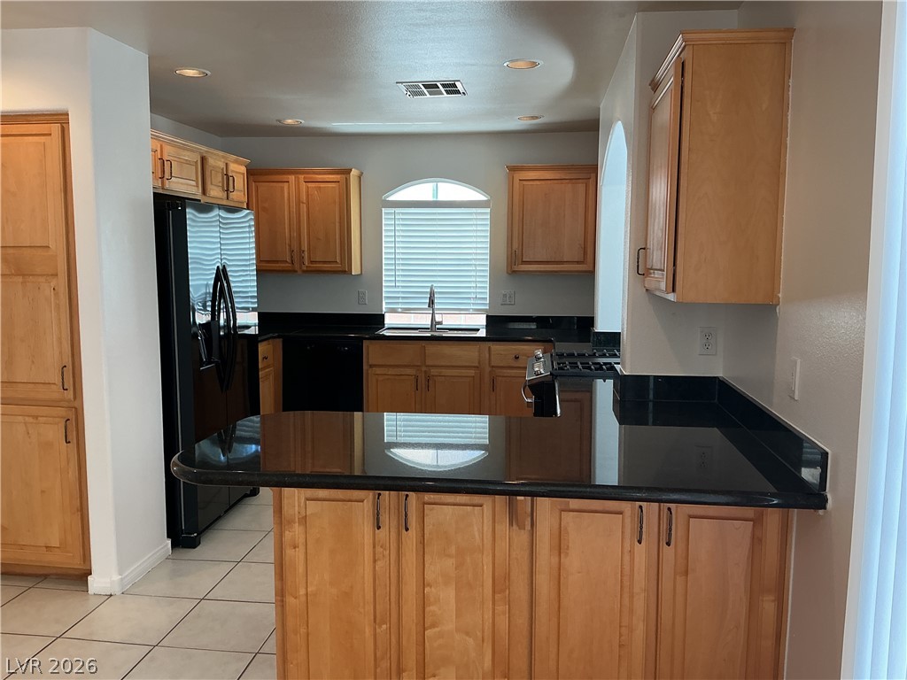 10975 Calcedonian Street Las Vegas, NV 89141 - Photo 4 of 25 This spacious kitchen offers ample cabinetry, sleek countertops, and modern appliances for culinary pursuits.