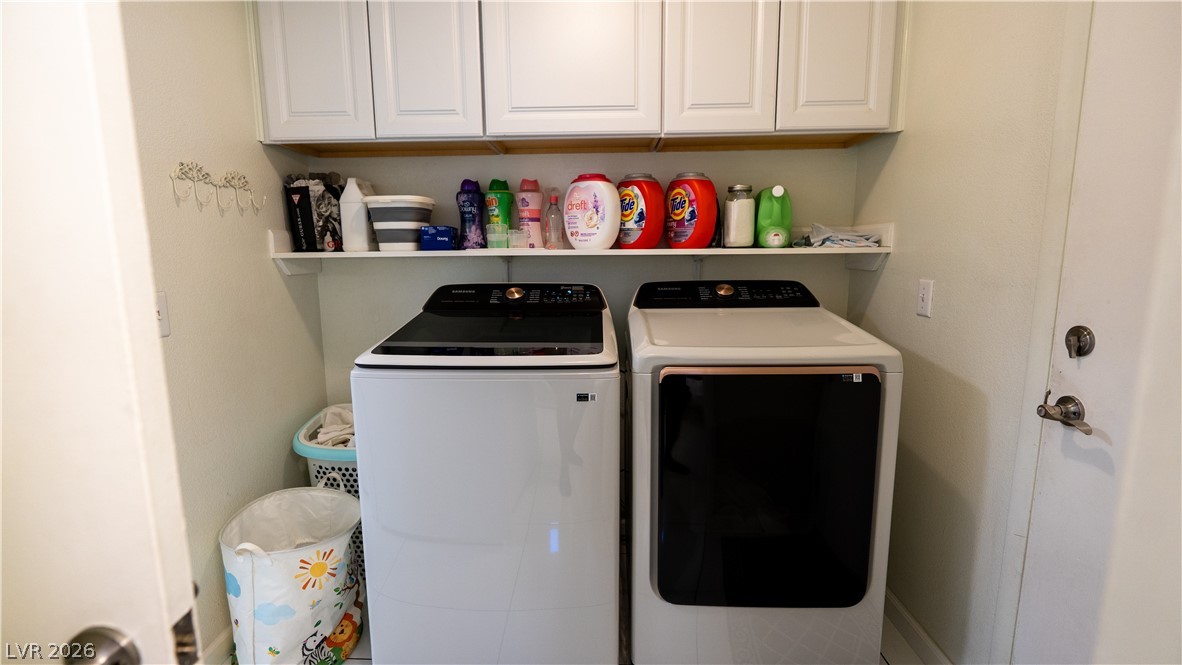 6429 Winding Ridge Las Vegas, NV 89156 - Photo 11 of 16 Functional laundry room equipped with upper cabinetry and practical shelving for storage.