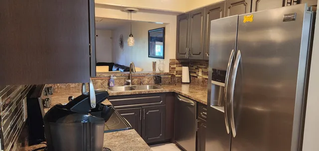 a kitchen with a refrigerator and a sink