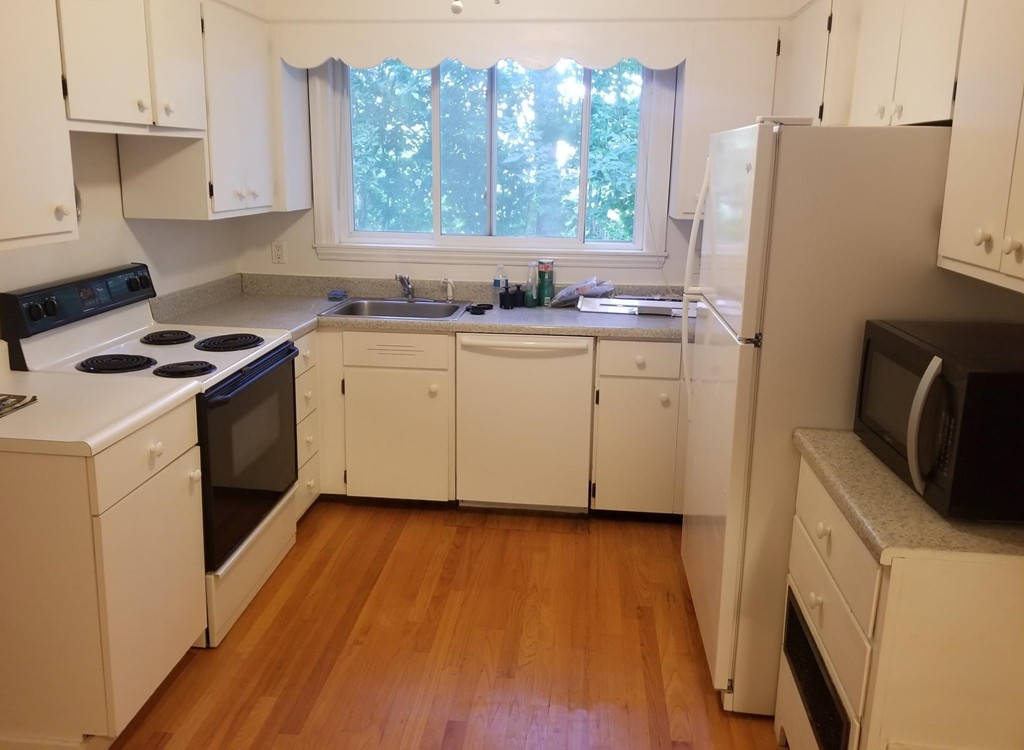 50 Marion Road, Unit 1 Arlington, MA 02474 - Photo 6 of 8 a kitchen with a refrigerator stove and sink