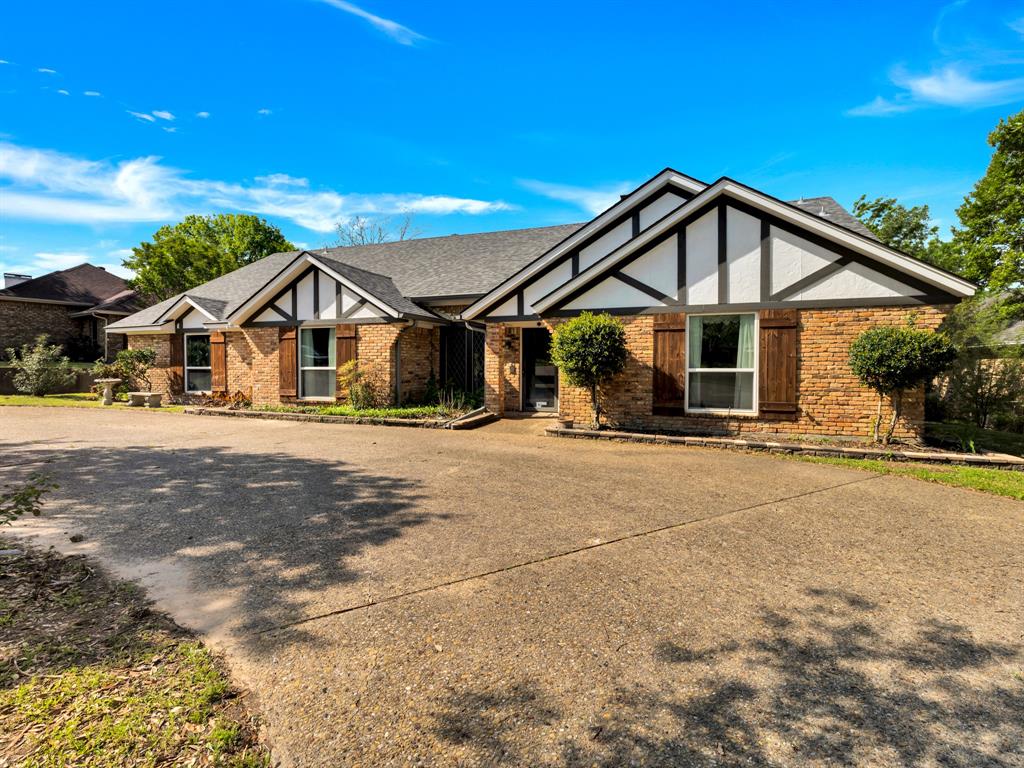 1770 Plummer Drive Rockwall, TX 75087 - Photo 1 of 1 Tudor home featuring stucco siding, brick siding, and a shingled roof