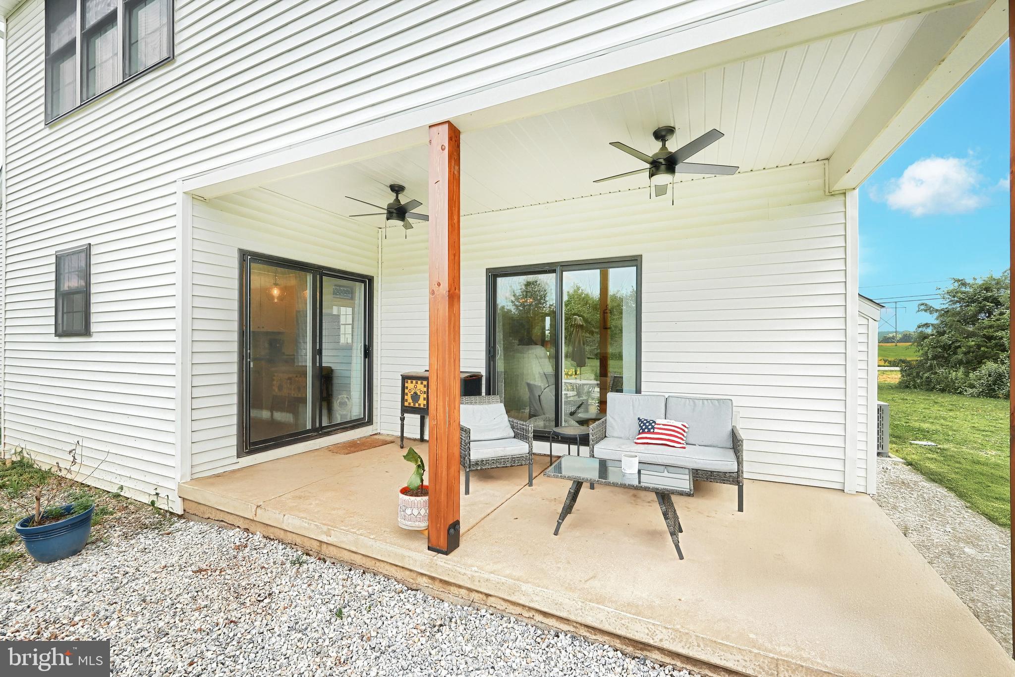 4575 Lewisberry Road York, PA 17404 - Photo 15 of 56 a patio with table and chairs and potted plants