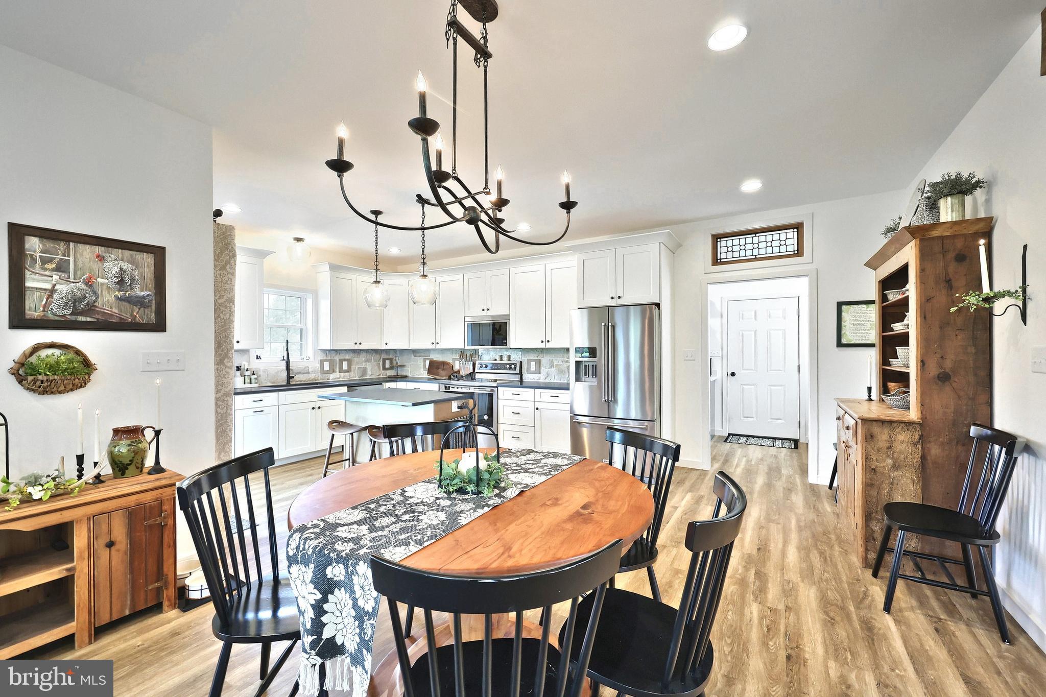 4575 Lewisberry Road York, PA 17404 - Photo 21 of 56 a view of a dining room and livingroom with furniture wooden floor a chandelier