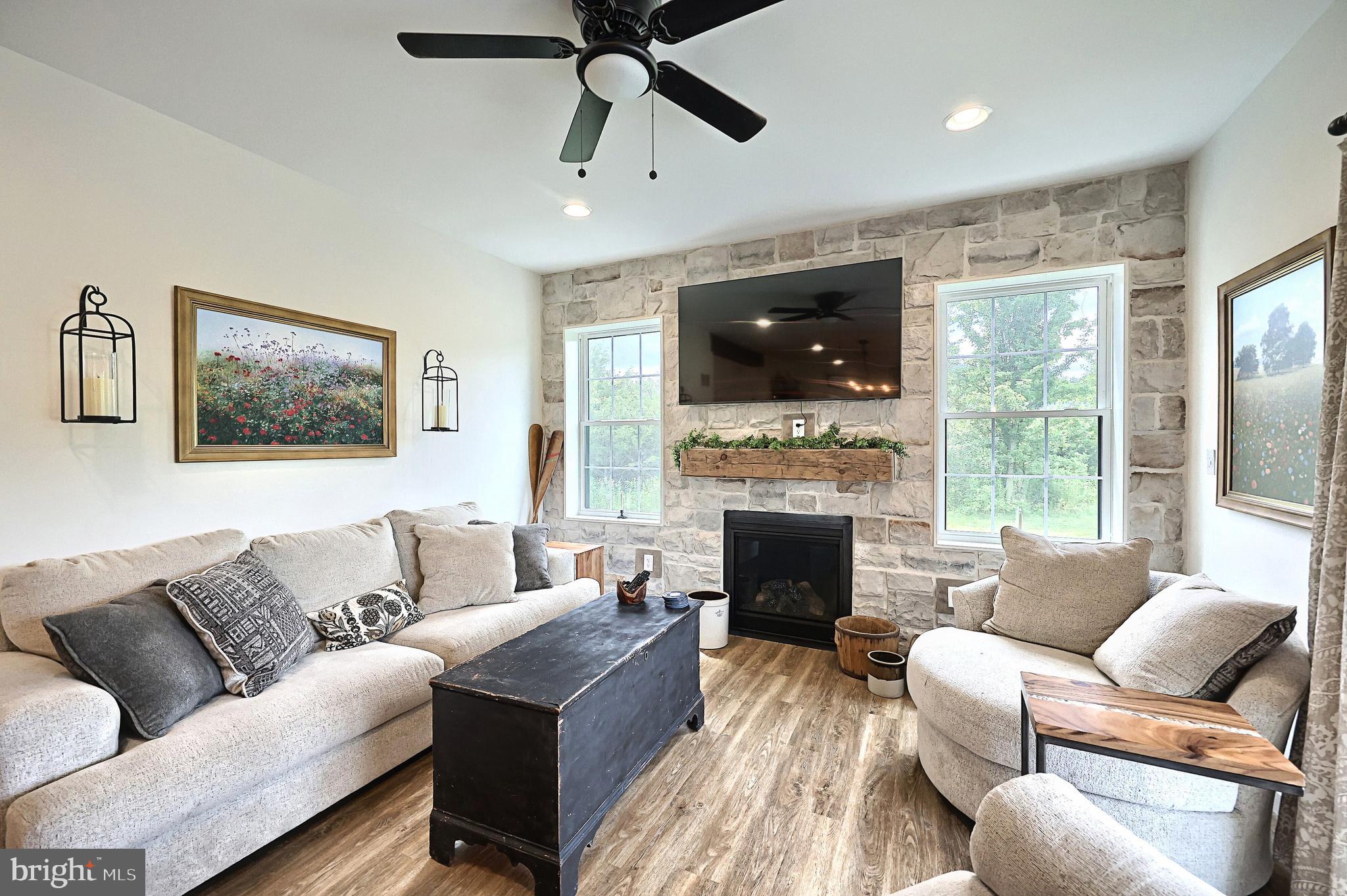 4575 Lewisberry Road York, PA 17404 - Photo 22 of 56 a living room with furniture a flat screen tv and a fireplace
