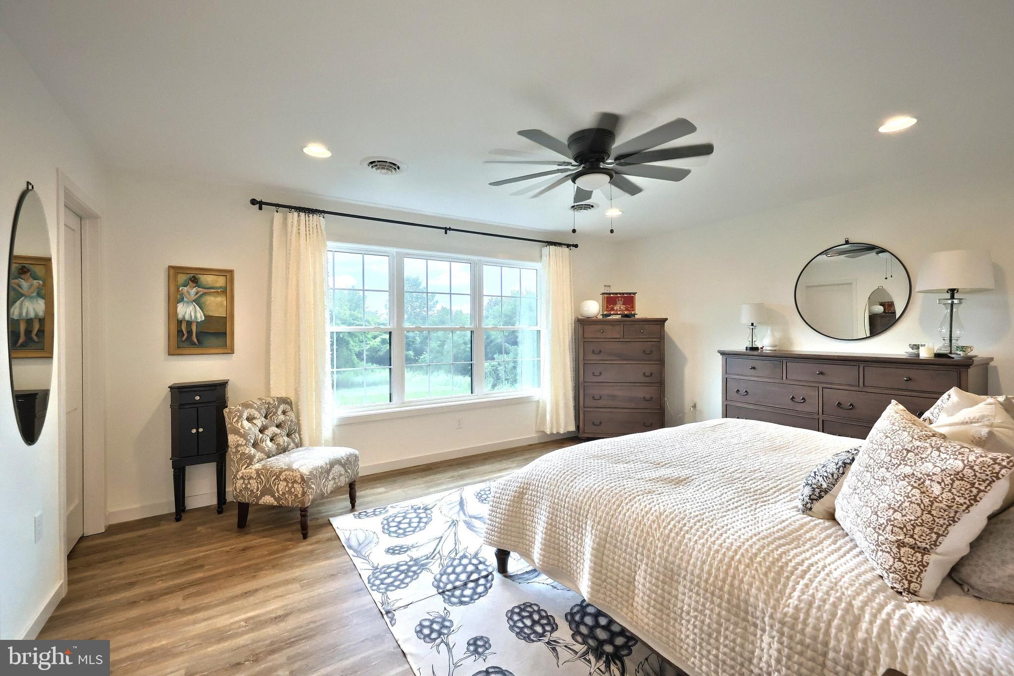 4575 Lewisberry Road York, PA 17404 - Photo 40 of 56 a bedroom with a large bed and a chandelier