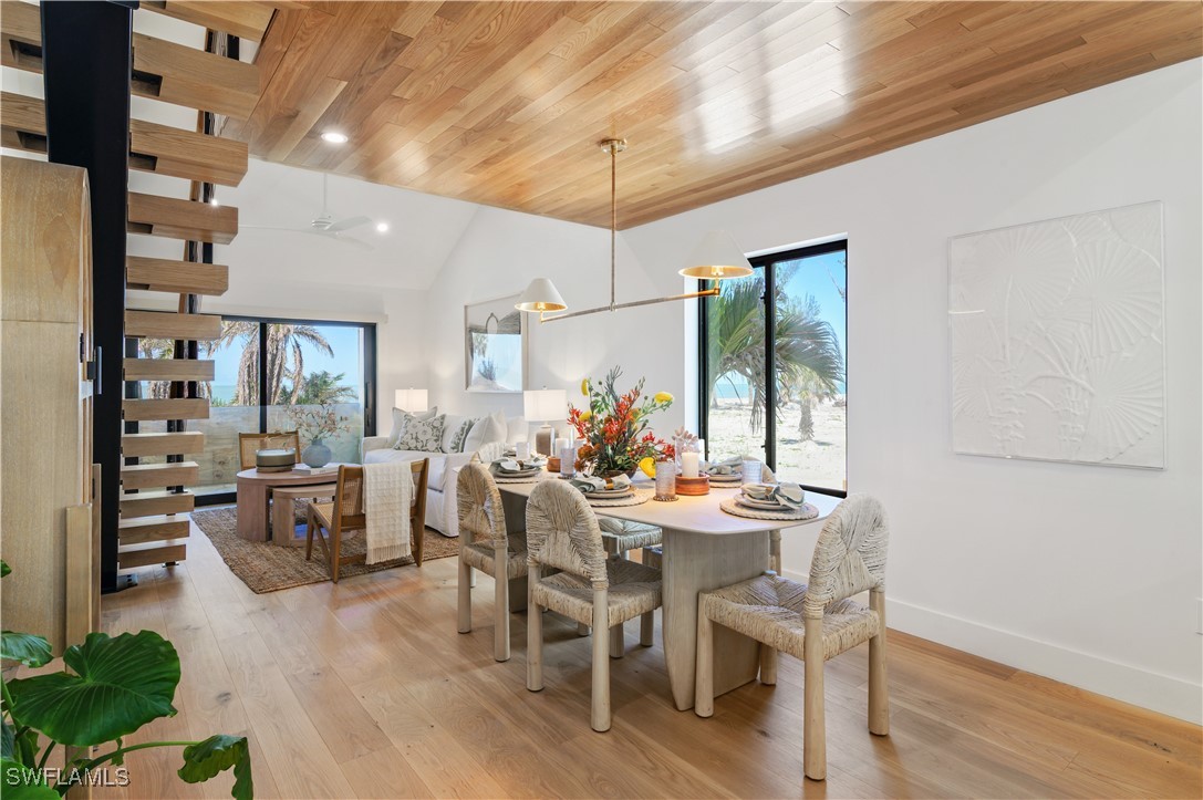 1411 Beach Cottages, Unit 1411 Captiva, FL 33924 - Photo 12 of 40 a view of a dining room with furniture window and wooden floor