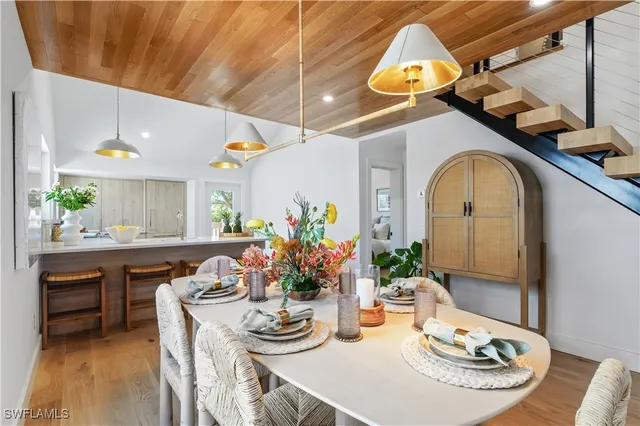 a dining room with furniture and wooden floor