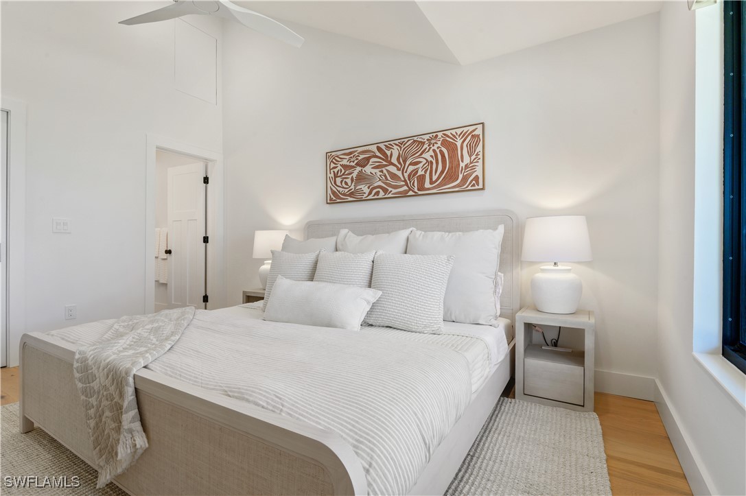 1411 Beach Cottages, Unit 1411 Captiva, FL 33924 - Photo 16 of 40 a bedroom with a bed and a lamp