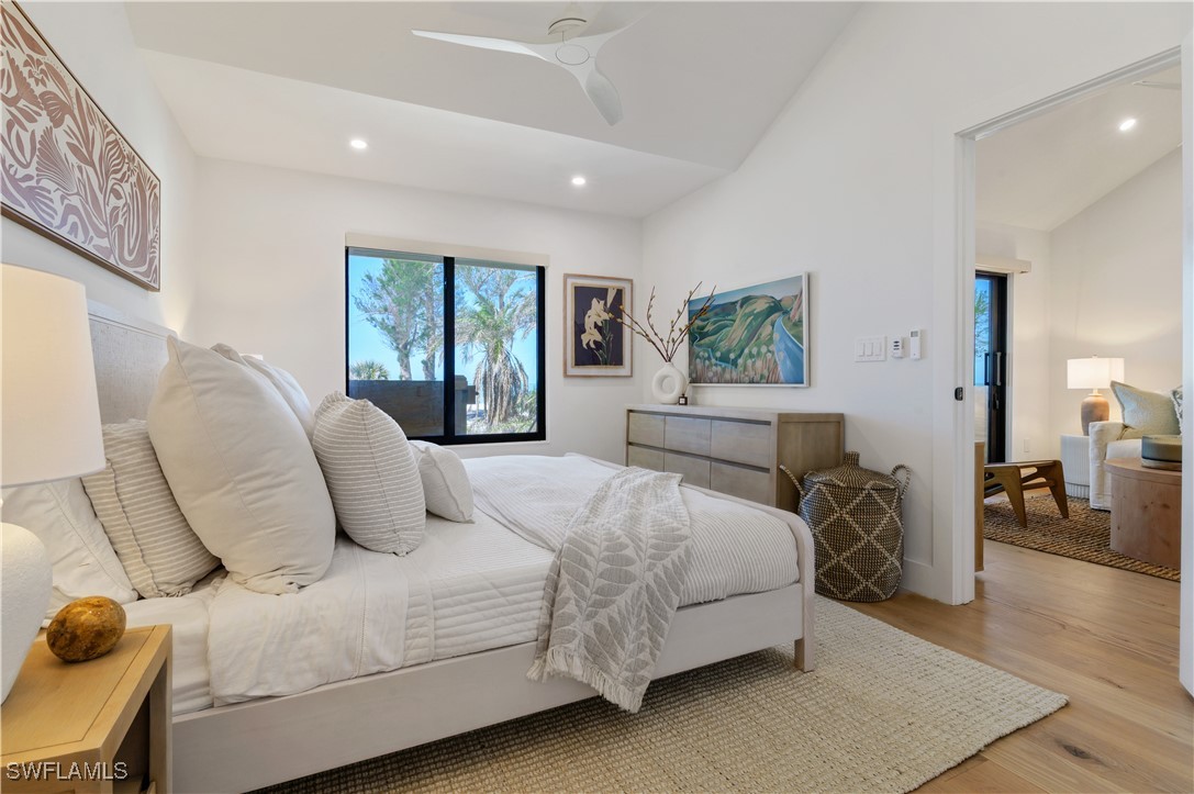 1411 Beach Cottages, Unit 1411 Captiva, FL 33924 - Photo 18 of 40 a bedroom with a large bed and a large window