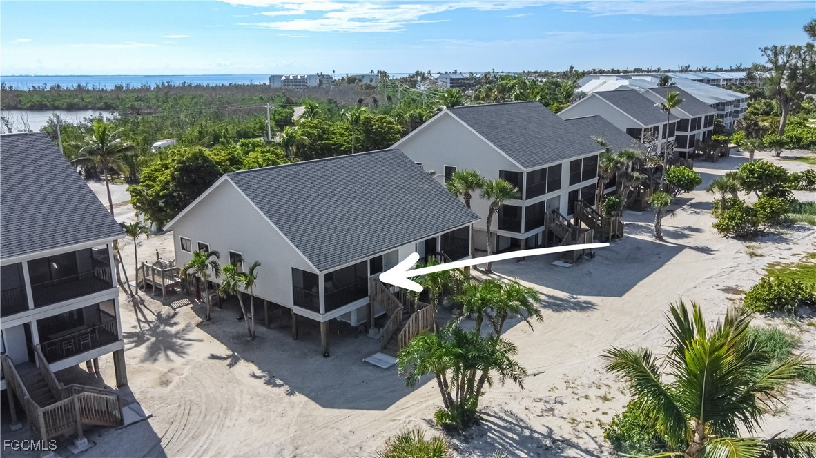 1411 Beach Cottages, Unit 1411 Captiva, FL 33924 - Photo 2 of 40 an aerial view of a house with yard and mountain view in back