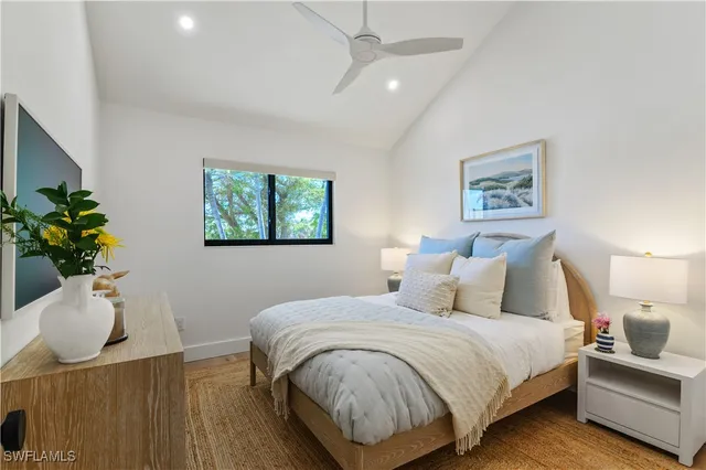 a spacious bedroom with a bed and a chandelier