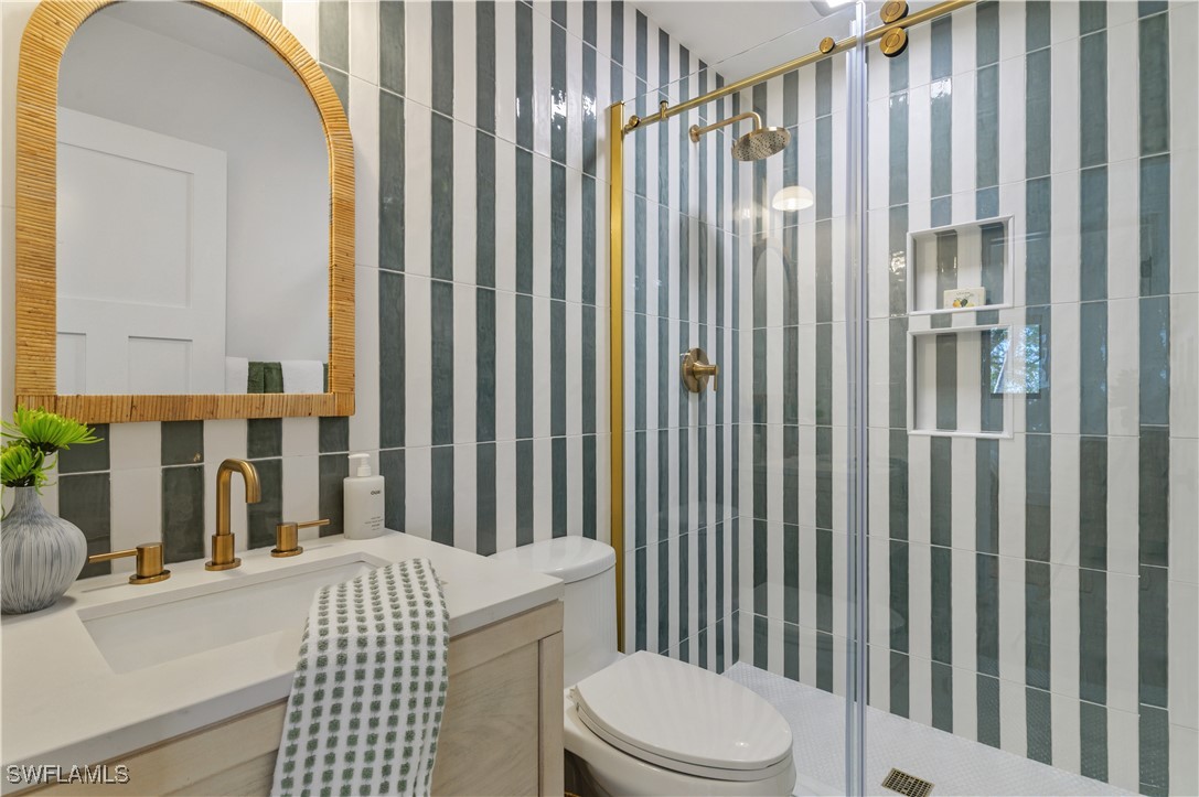 1411 Beach Cottages, Unit 1411 Captiva, FL 33924 - Photo 23 of 40 a bathroom with a sink toilet and shower