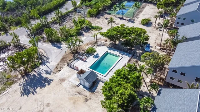 an aerial view of a house with a yard and garden