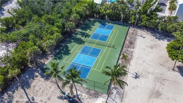 an aerial view of a house with a yard and large trees