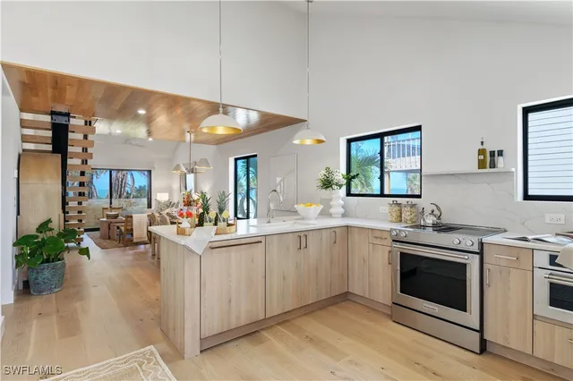 a kitchen with sink stove and cabinets