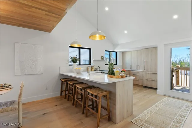 a kitchen with cabinets and chairs