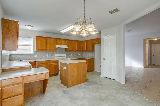 a bathroom with a granite countertop sink toilet and mirror