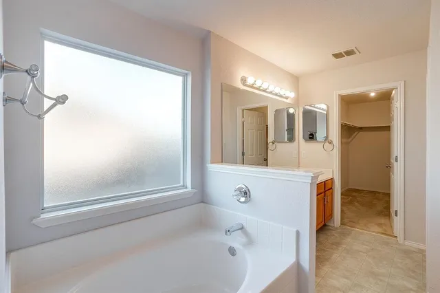 a view of a house with a porch and a large tree