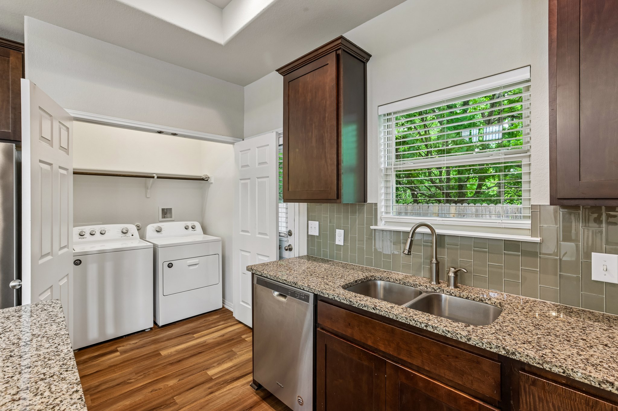 808 Totis Road Austin, TX 78748 - Photo 11 of 40 Kitchen featuring granite countertops, a double stainless steel sink, and a tiled backsplash
