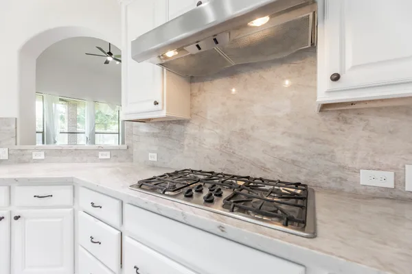 a bathroom with a granite countertop sink a mirror and a bathtub