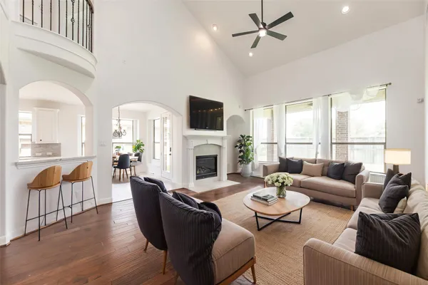 a view of a hallway with wooden floor and a kitchen