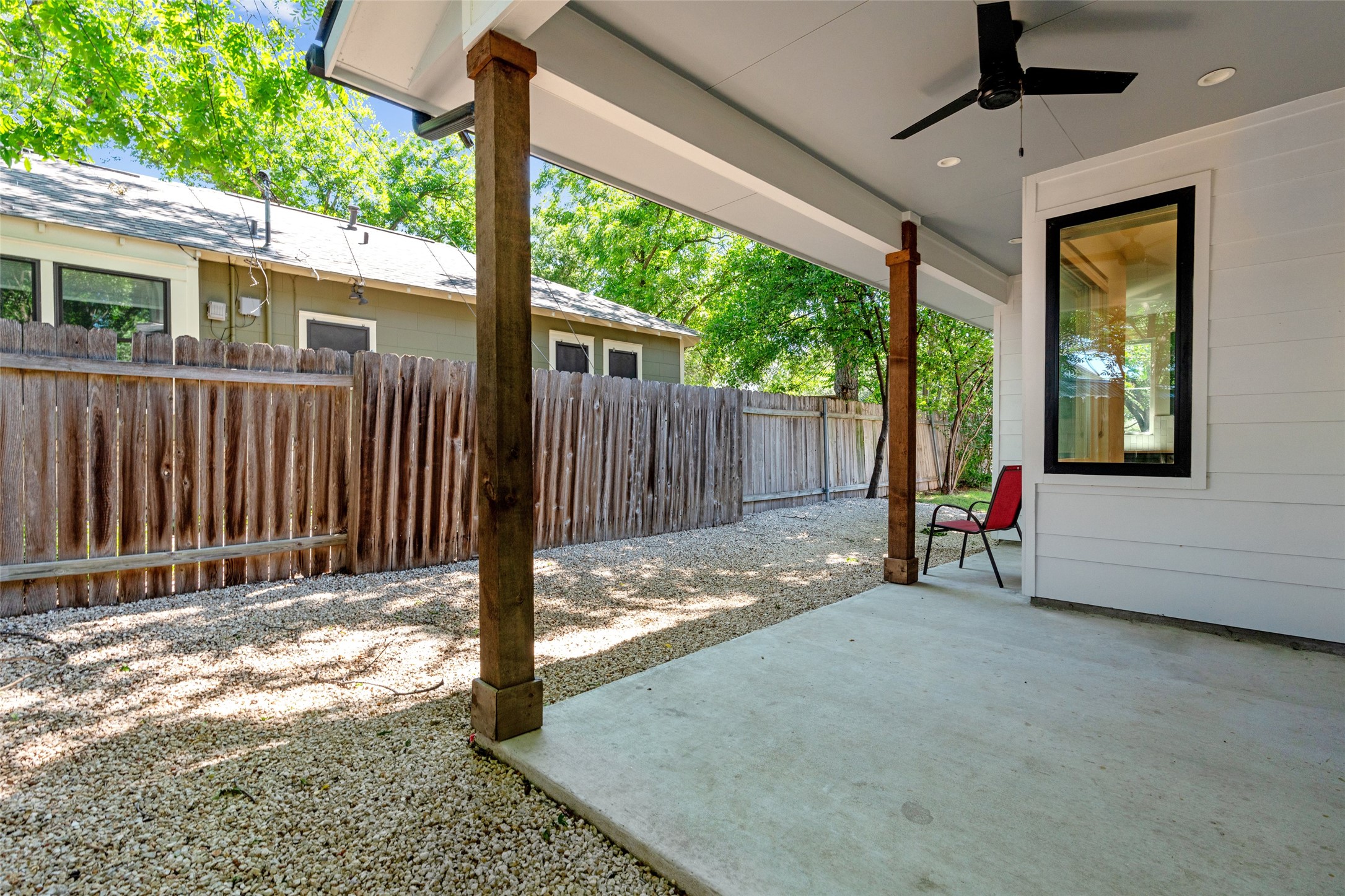 5200 Grover Avenue Austin, TX 78756 - Photo 29 of 32 Covered patio featuring a concrete surface, exposed wood structural columns, a ceiling fan and fully fenced for privacy