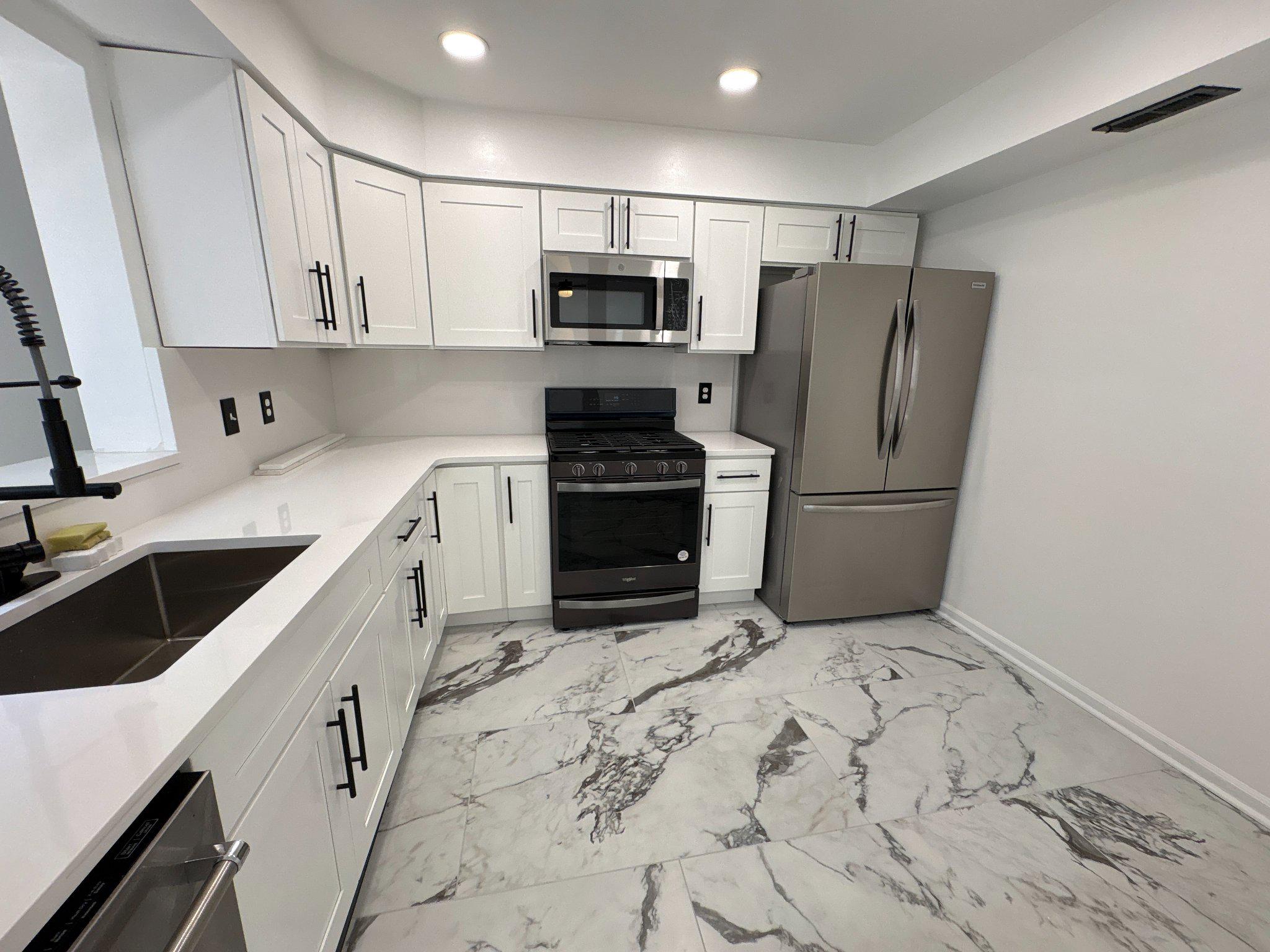 72304 Delaire Landing Road, Unit 304 Philadelphia, PA 19114 - Photo 18 of 56 Sleek modern kitchen with elegant finishes.
