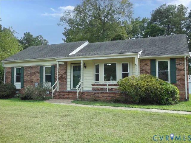 a front view of house with yard and outdoor seating