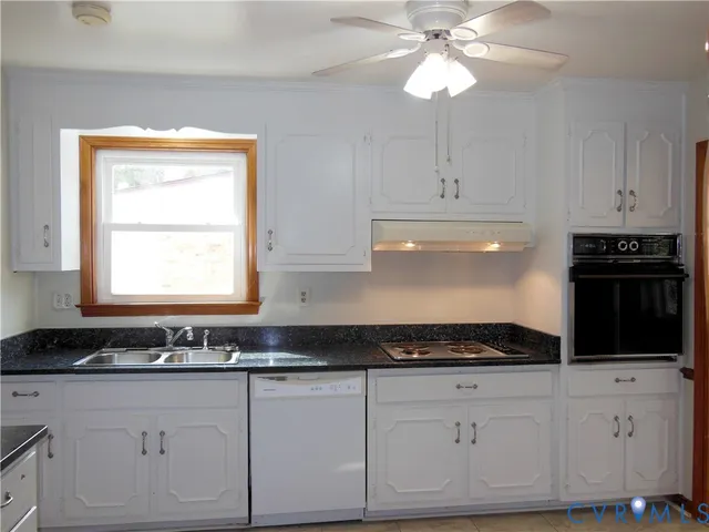 a kitchen with granite countertop white cabinets and black appliances
