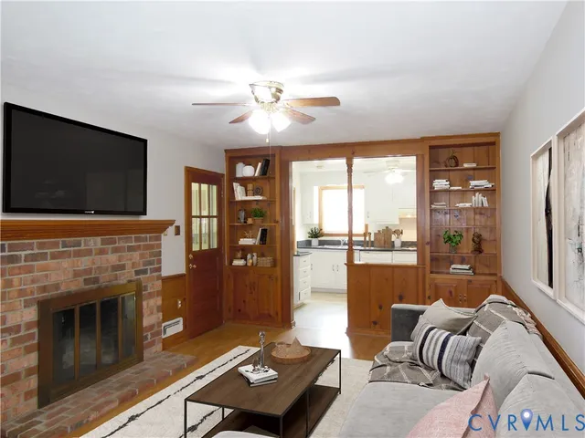 a living room with furniture fireplace and flat screen tv