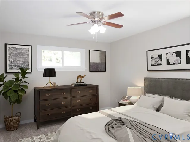 a bedroom with a bed and a potted plant