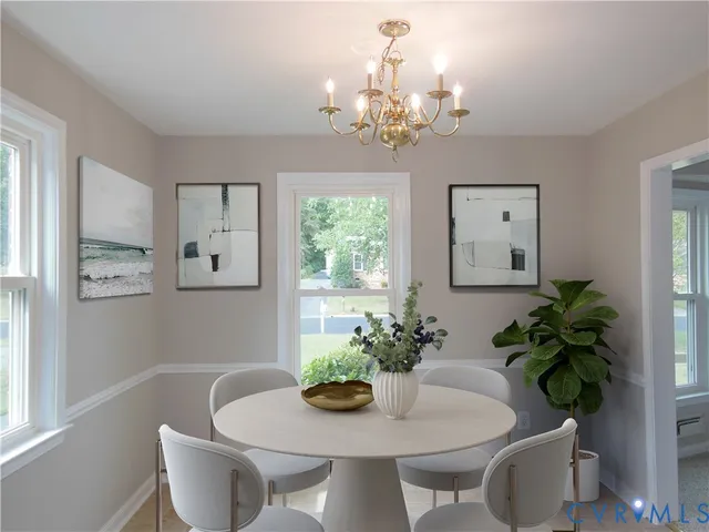 a dining room with furniture potted plants and wooden floor