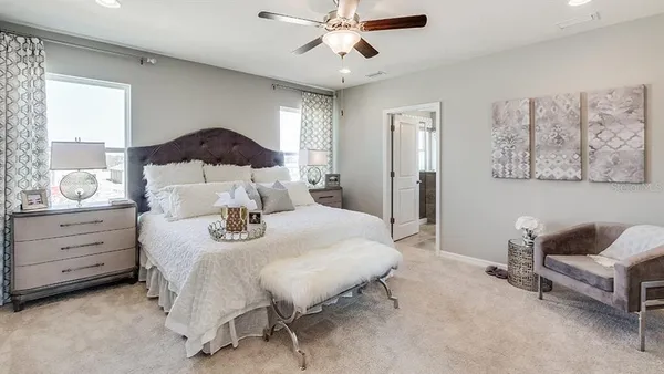 a bed room with a bed and a chair