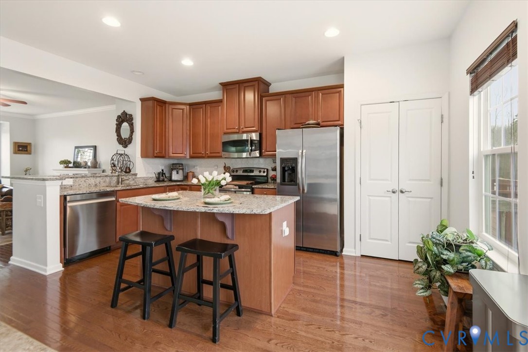 4836 Skyline Ridge Drive Midlothian, VA 23112 - Photo 6 of 44 a kitchen with stainless steel appliances kitchen island granite countertop a refrigerator and a sink