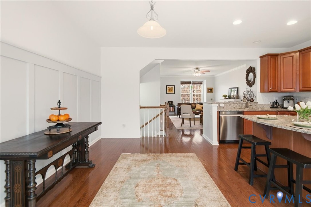 4836 Skyline Ridge Drive Midlothian, VA 23112 - Photo 7 of 44 a living room with stainless steel appliances furniture a rug and a kitchen view