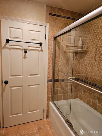 a bathroom with a shower and a bath tub