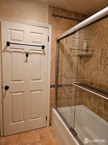 a bathroom with a shower and a bath tub