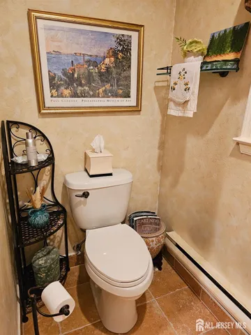 a white toilet sitting next to a bathroom and a shower