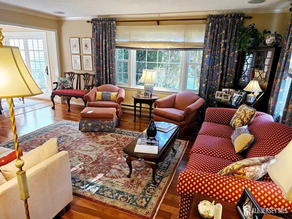 a living room with furniture and floor to ceiling windows