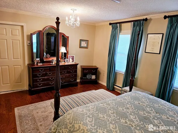 a bedroom with a bed and a mirror on dresser