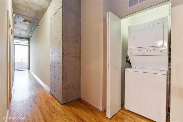 a view of a storage & utility room with closet wooden floor