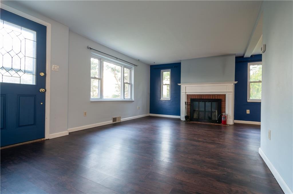 265 Chubbic Road Canonsburg, PA 15317 - Photo 6 of 22 an empty room with wooden floor fireplace and windows