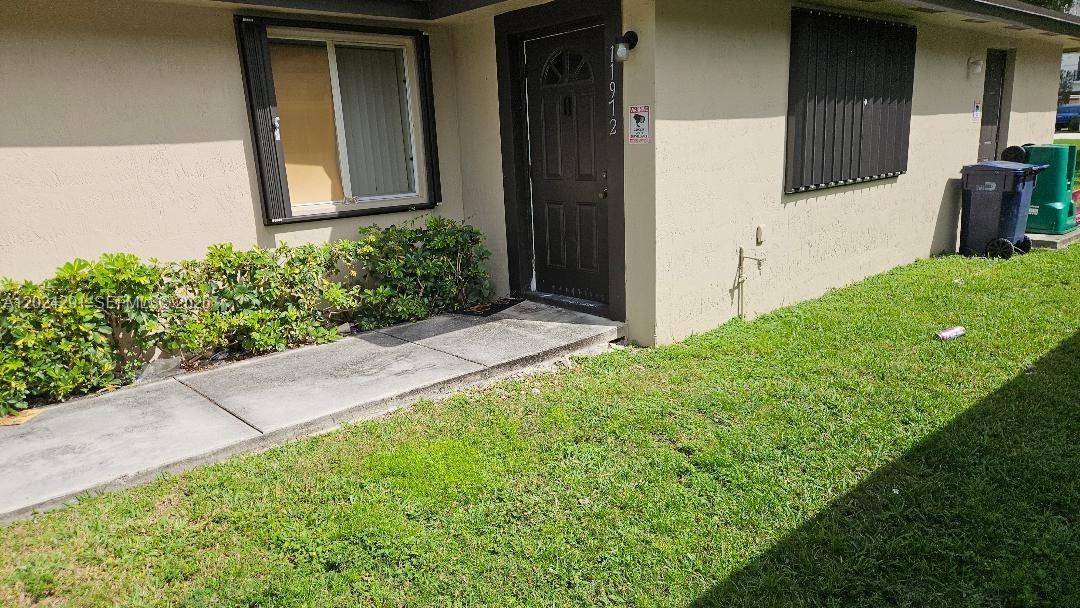 11970 Southwest 217th Street Miami, FL 33170 - Photo 3 of 10 a view of house with backyard and porch