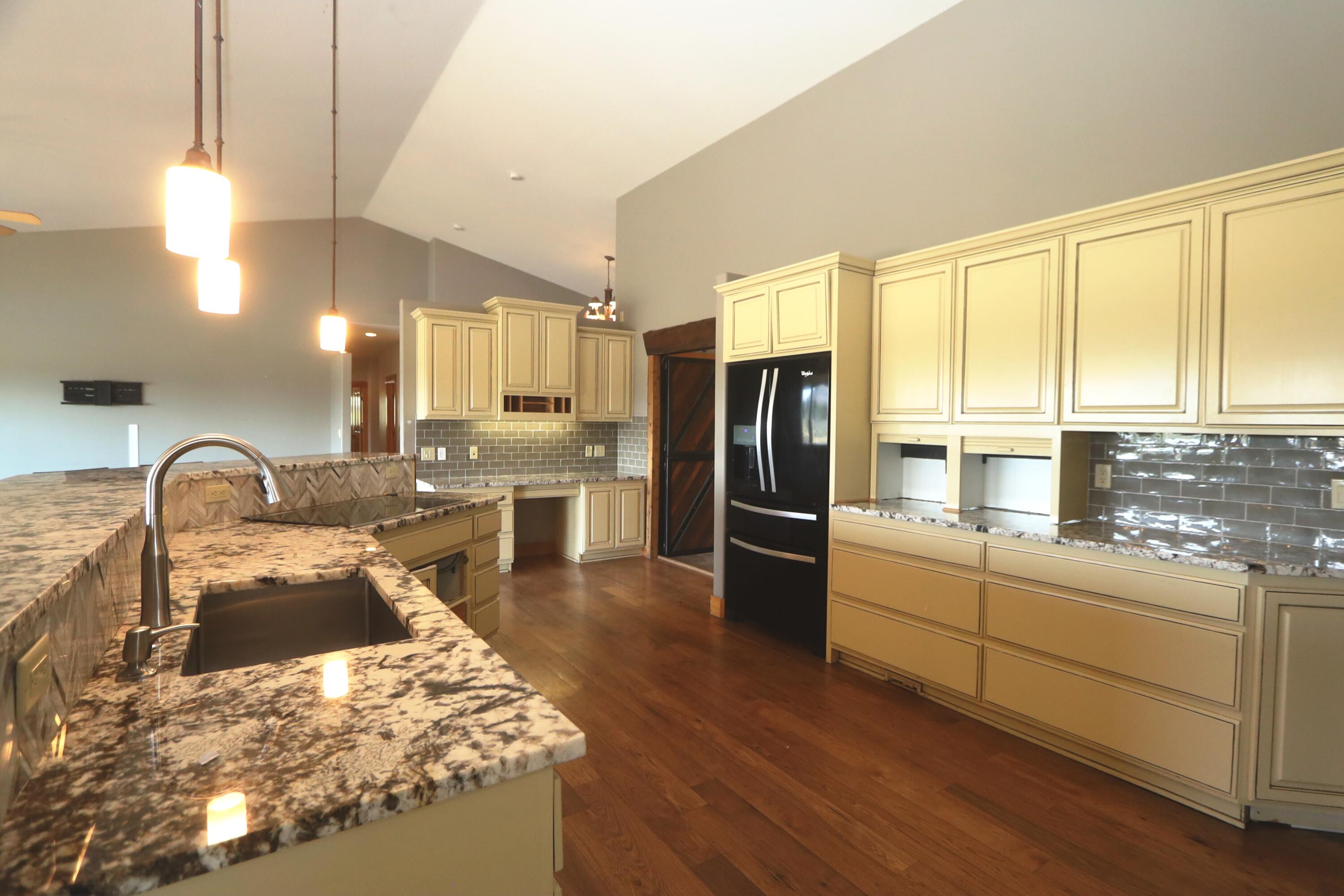 21491 Bear Creek Road Bend, OR 97701 - Photo 12 of 45 a kitchen with stainless steel appliances granite countertop a sink a stove and refrigerator