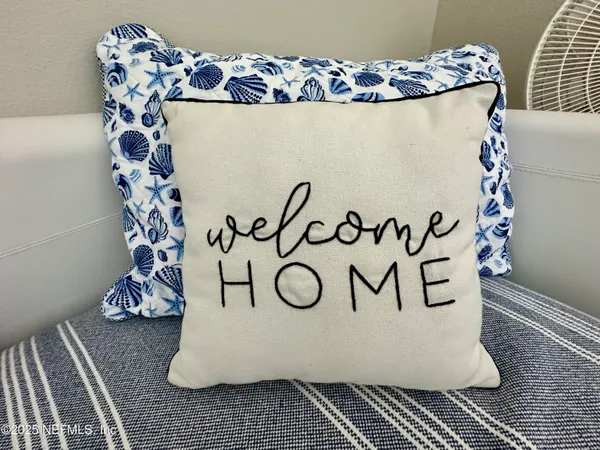 a kitchen with stainless steel appliances granite countertop a refrigerator a sink dishwasher a stove and white countertops with wooden floor